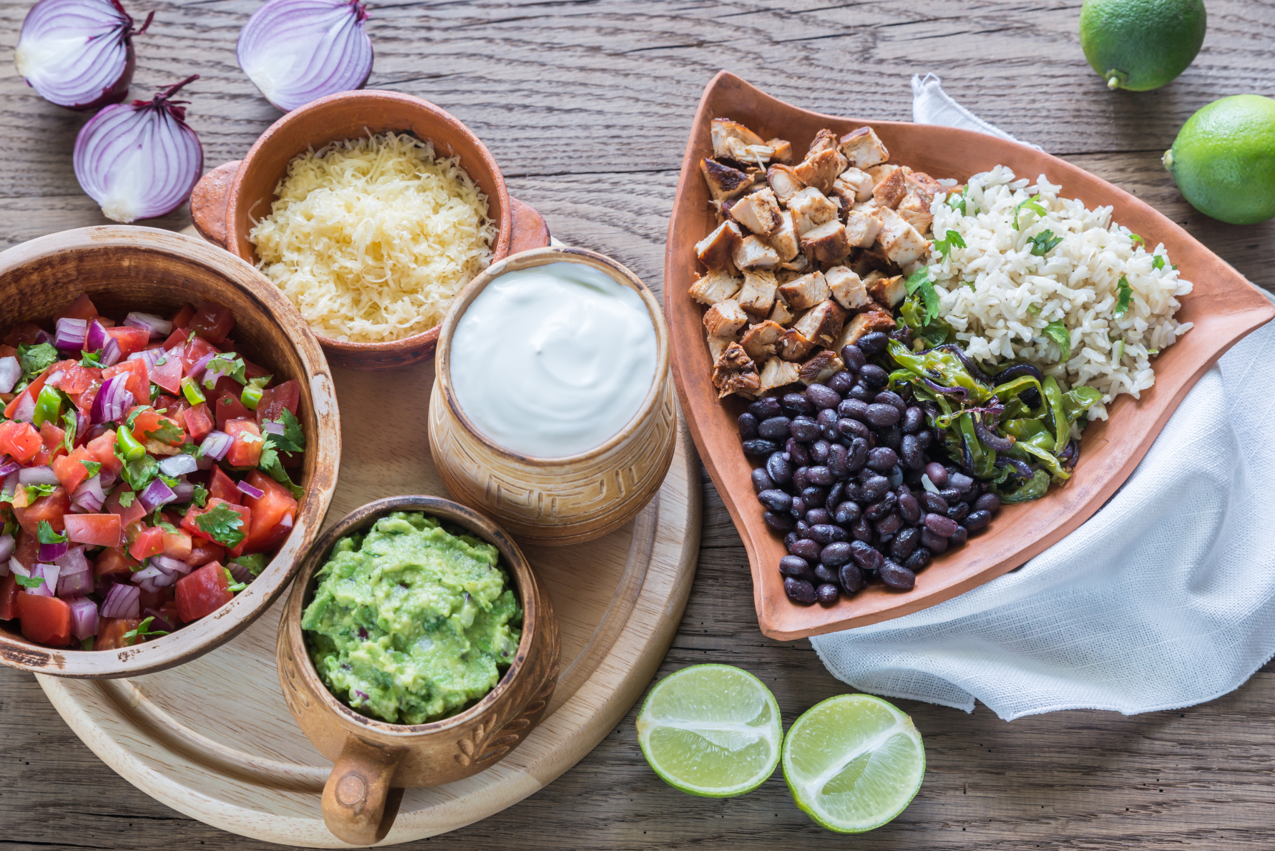 Taco Bar Ideas. Mexican food in bowls on a wooden table.