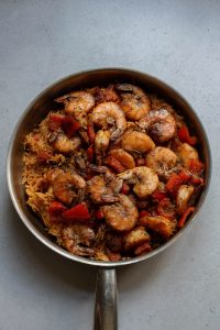 Shrimp and rice in a pan on a table.