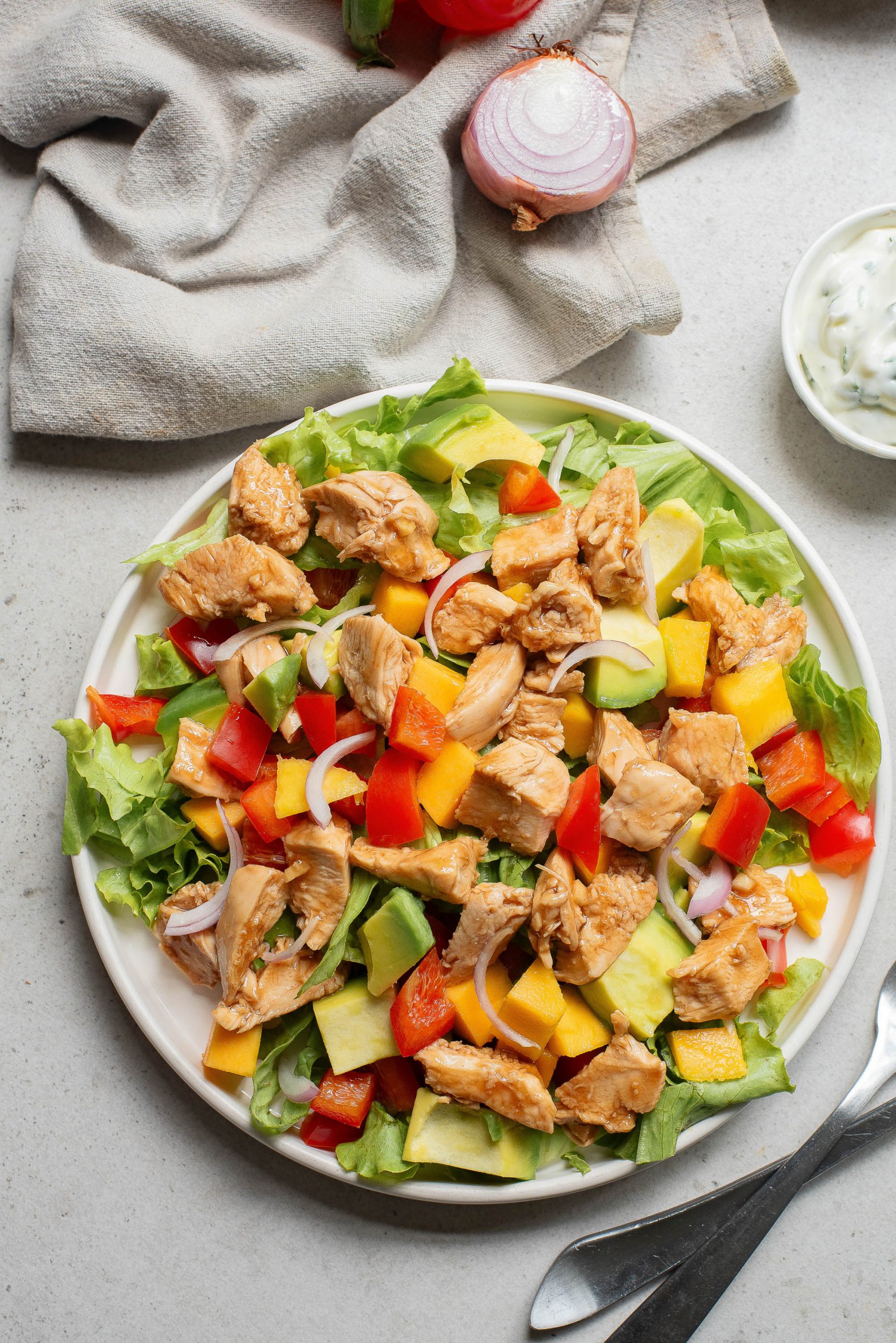 A plate of Hot Honey Garlic Chicken Saladwith chicken and vegetables.