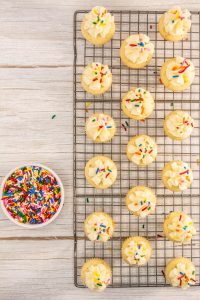 A rack of cookies with sprinkles on it.