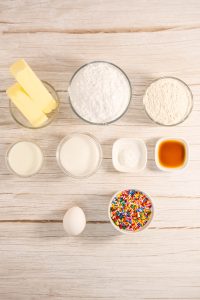 The ingredients of a cake on a wooden table.