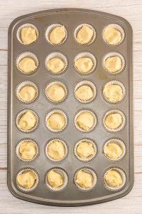 A tray of cupcakes in a pan.