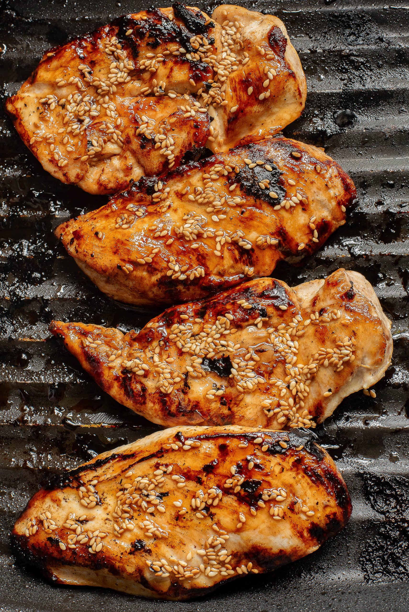 Honey Sriracha Sesame Chicken on a grill.