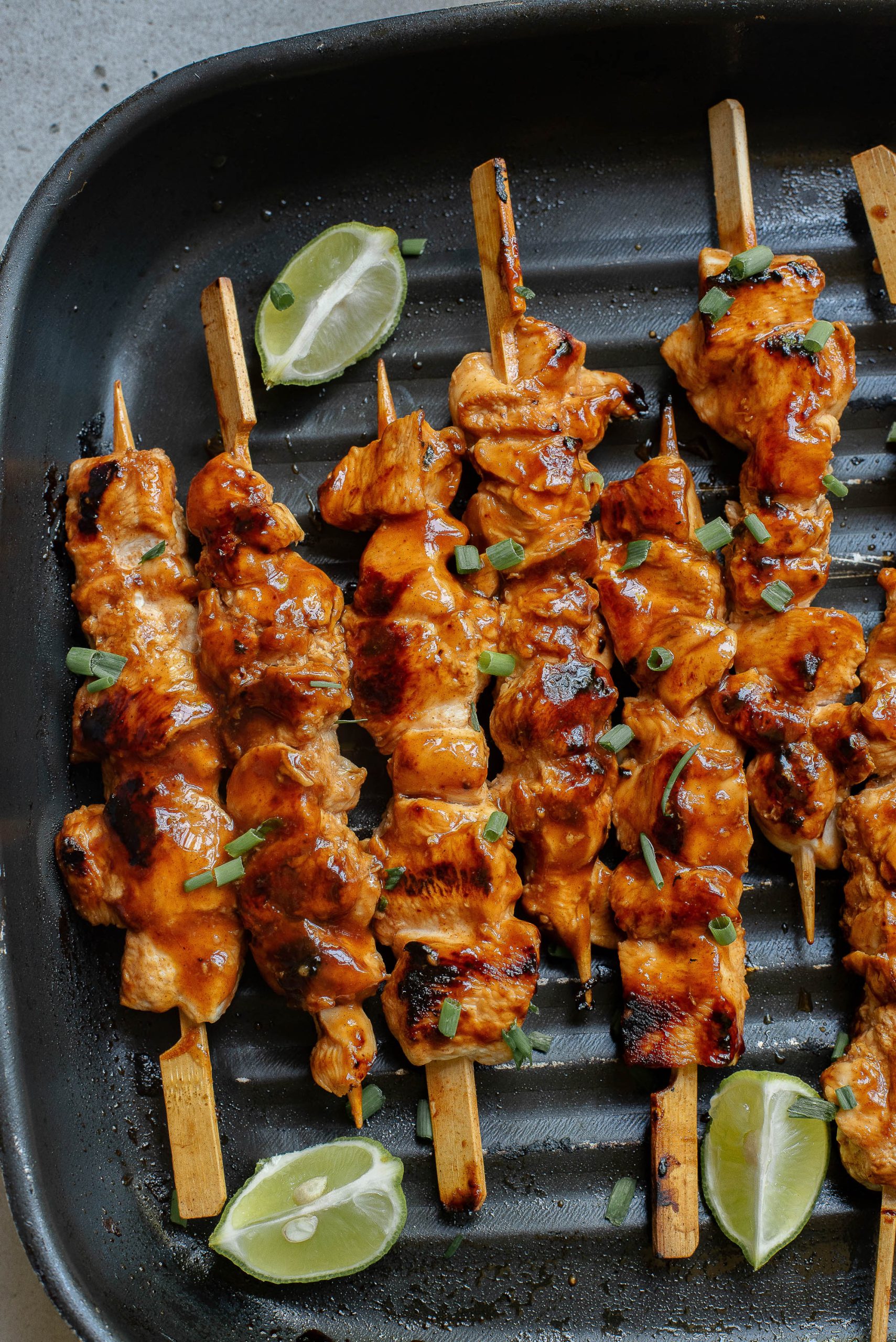A group of Honey Beer Chicken Kabobs on a grill.