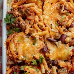 A casserole dish with meat, cheese and beans.