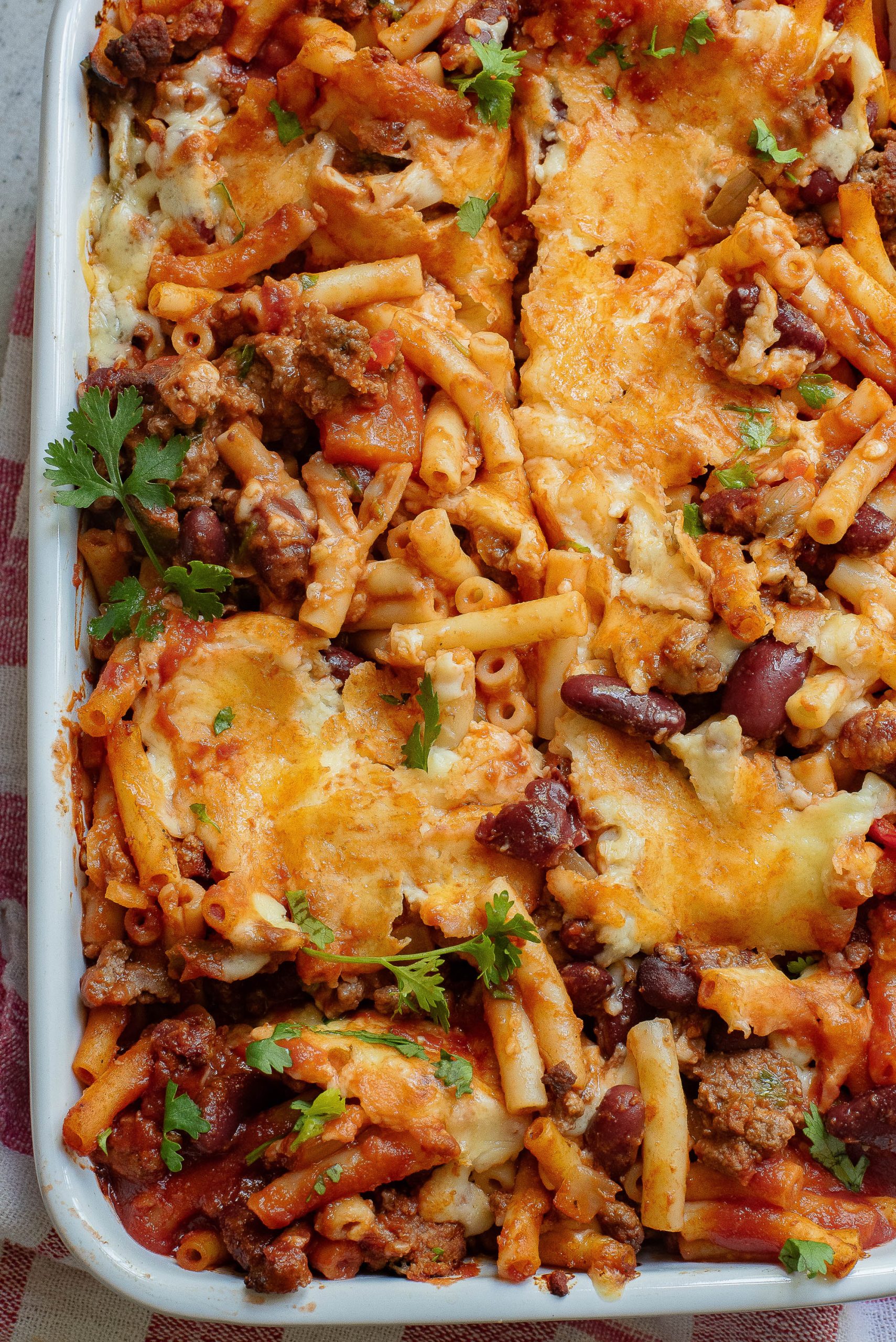 A casserole dish with meat, cheese and beans.