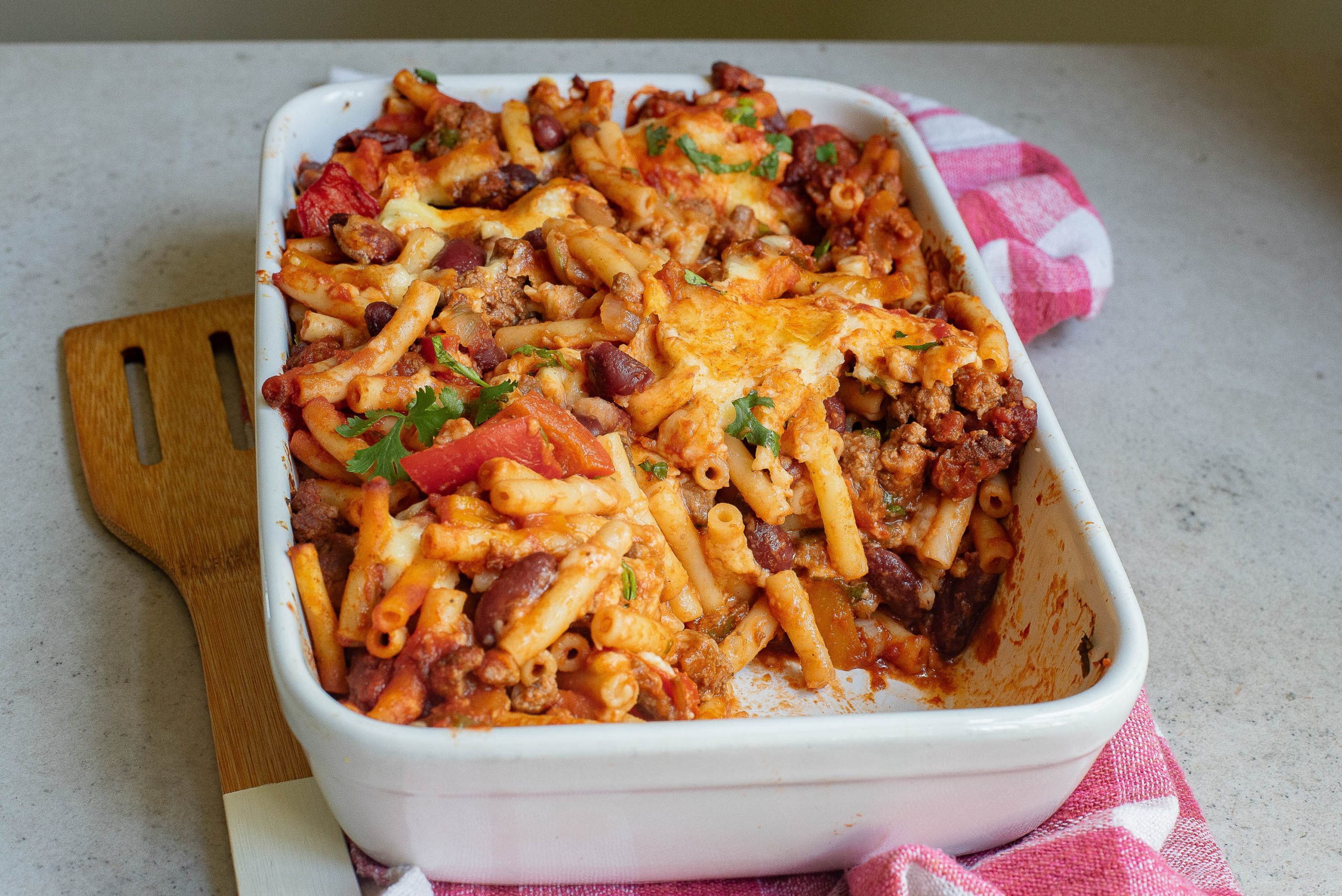 A casserole dish filled with pasta and beans.