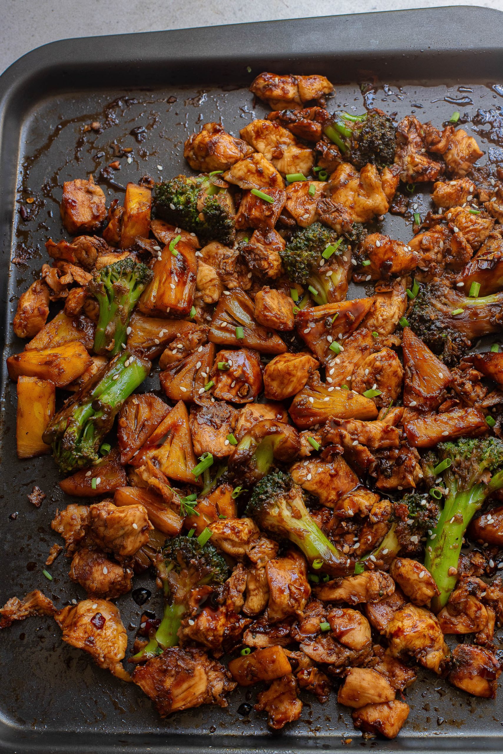 A pan with chicken and broccoli on it.