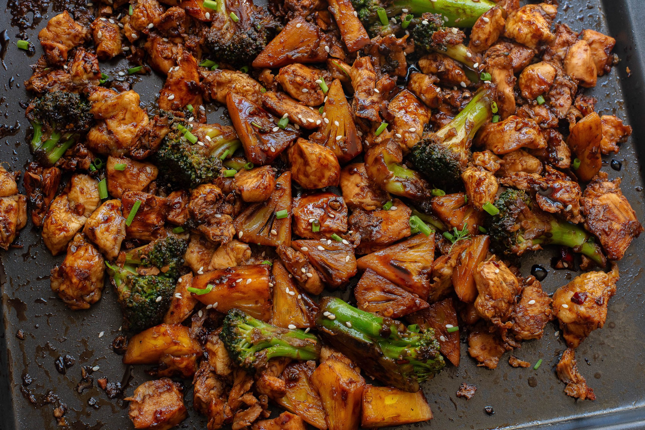 A pan with chicken and broccoli on it.