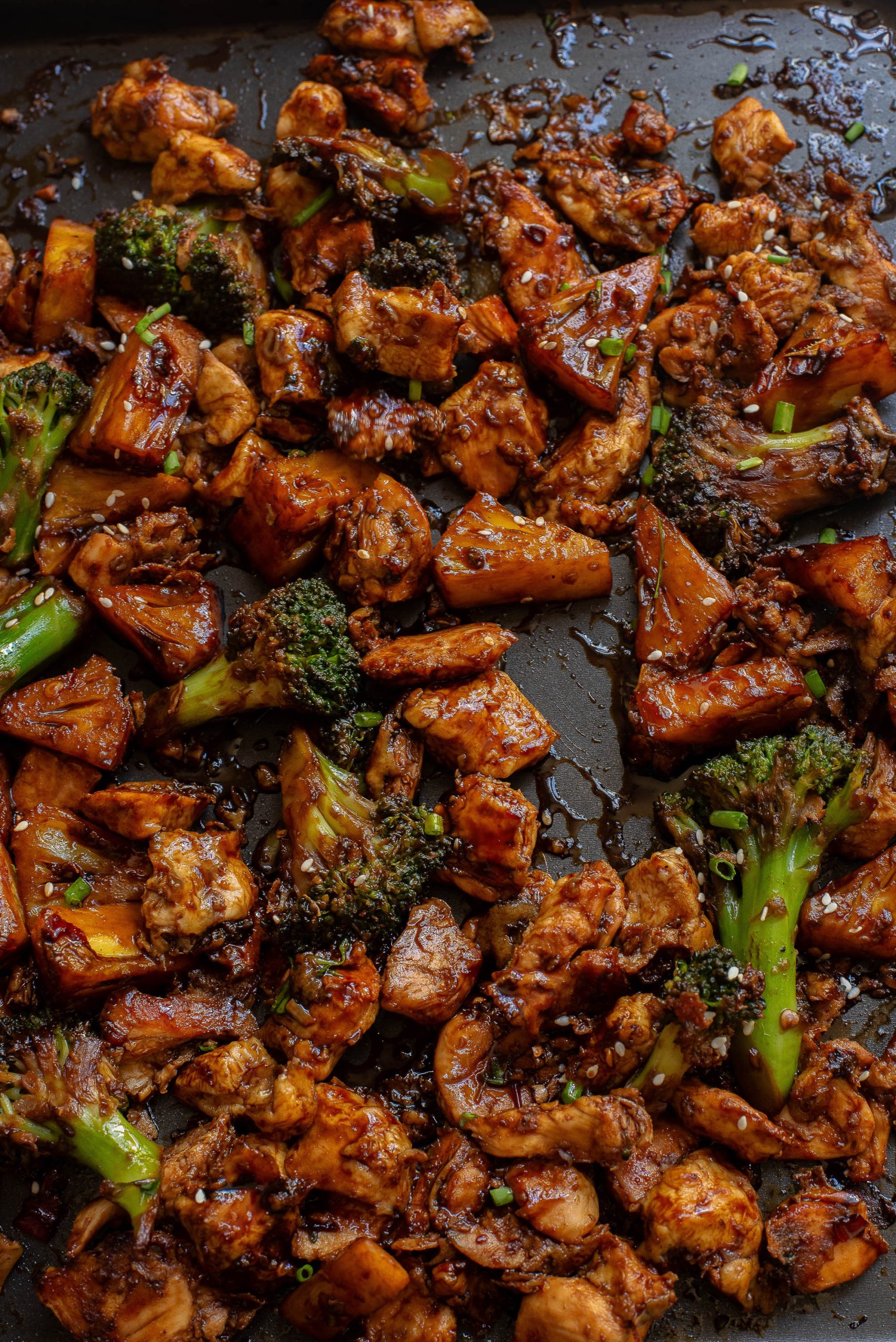 A pan with chicken and broccoli on it.