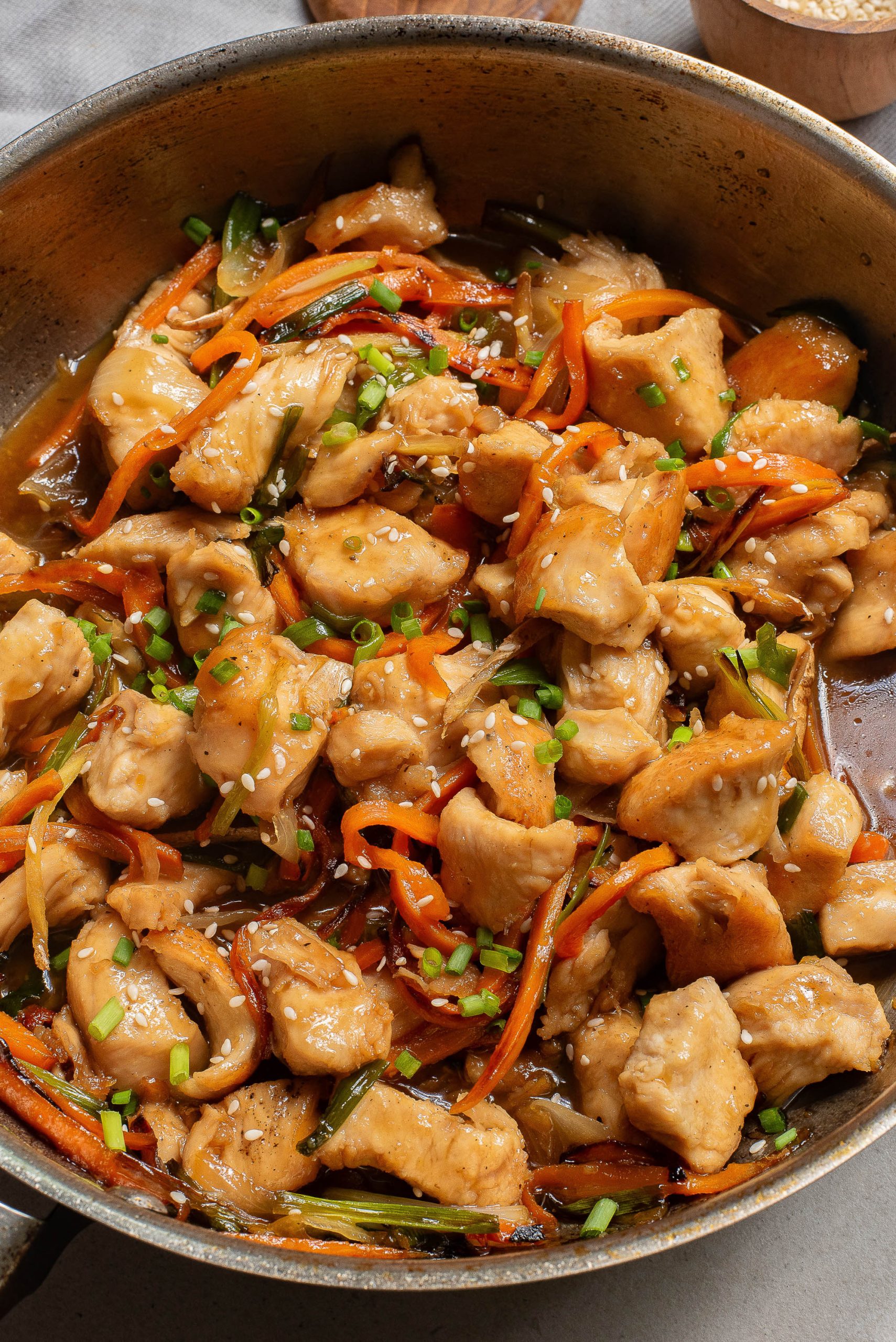 Stovetop Vietnamese Ginger Chicken in a skillet with carrots and onions.