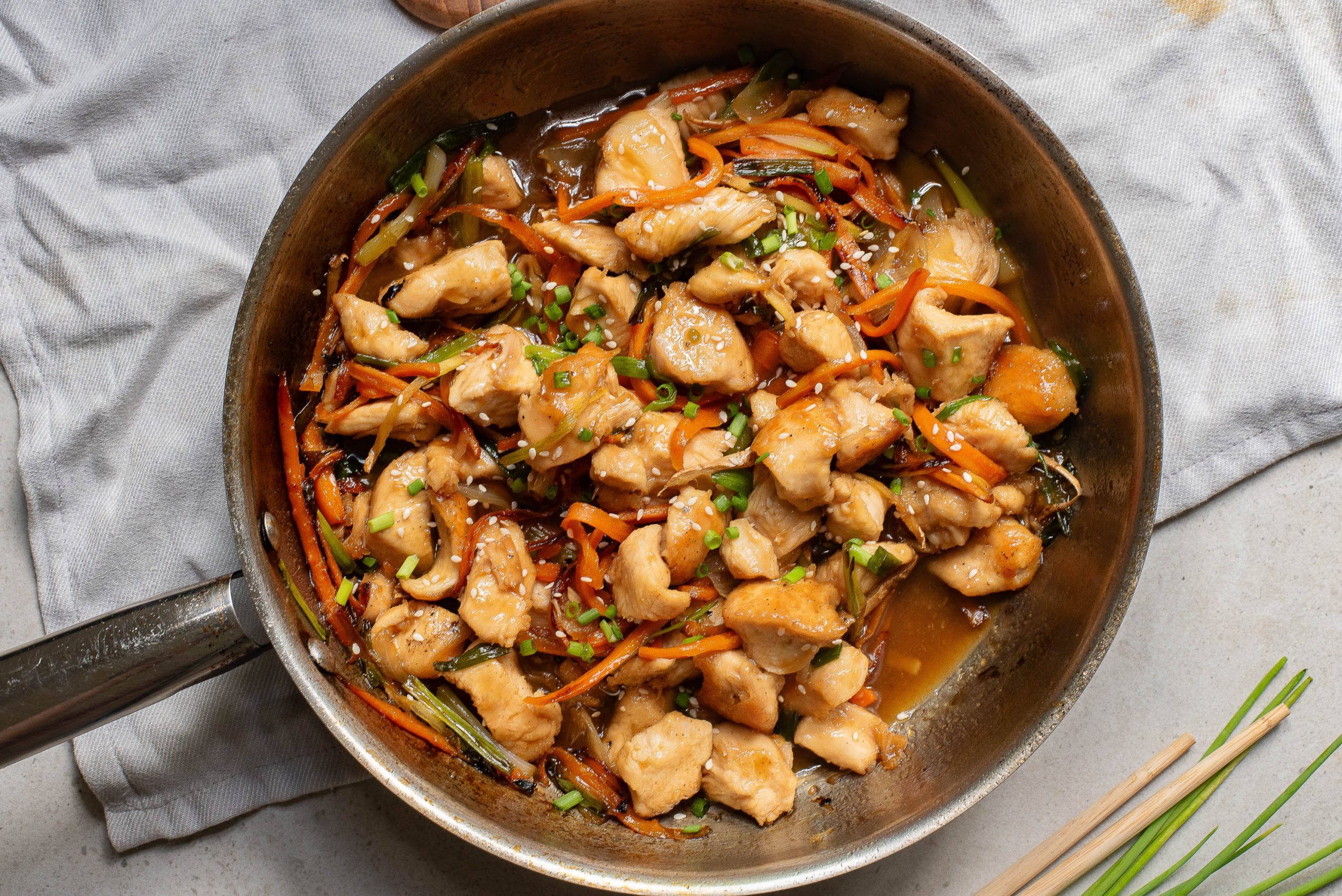 Stovetop Vietnamese Ginger Chicken in a pan with chopsticks.