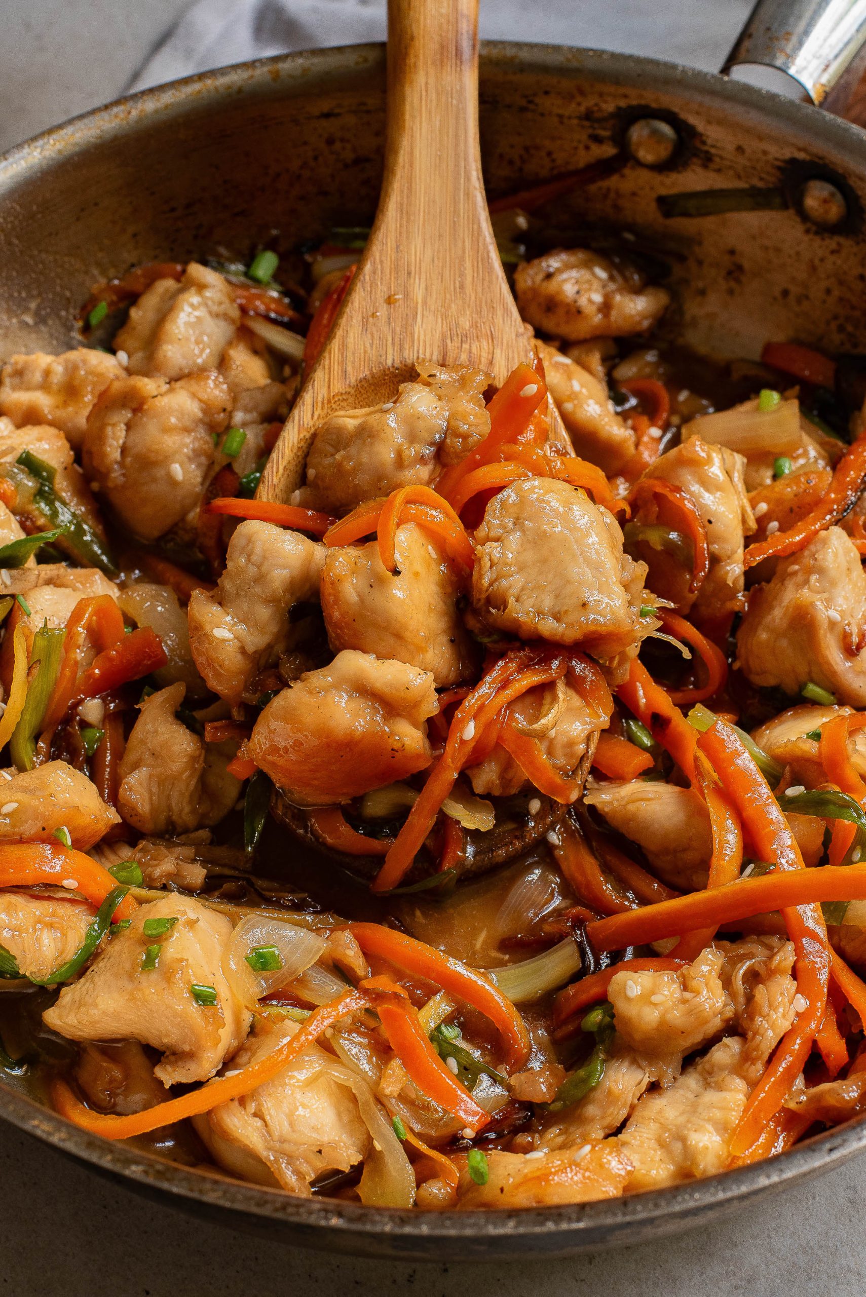Stovetop Vietnamese Ginger Chicken in a wok with carrots and onions.