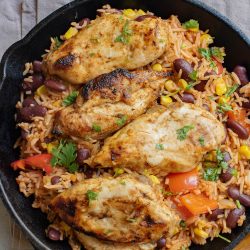 Chicken and rice in a skillet.