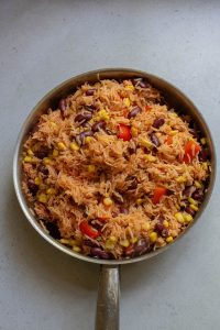 Mexican rice in a pan with beans and corn.