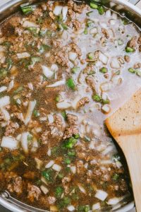 A pan with meat and vegetables in it.