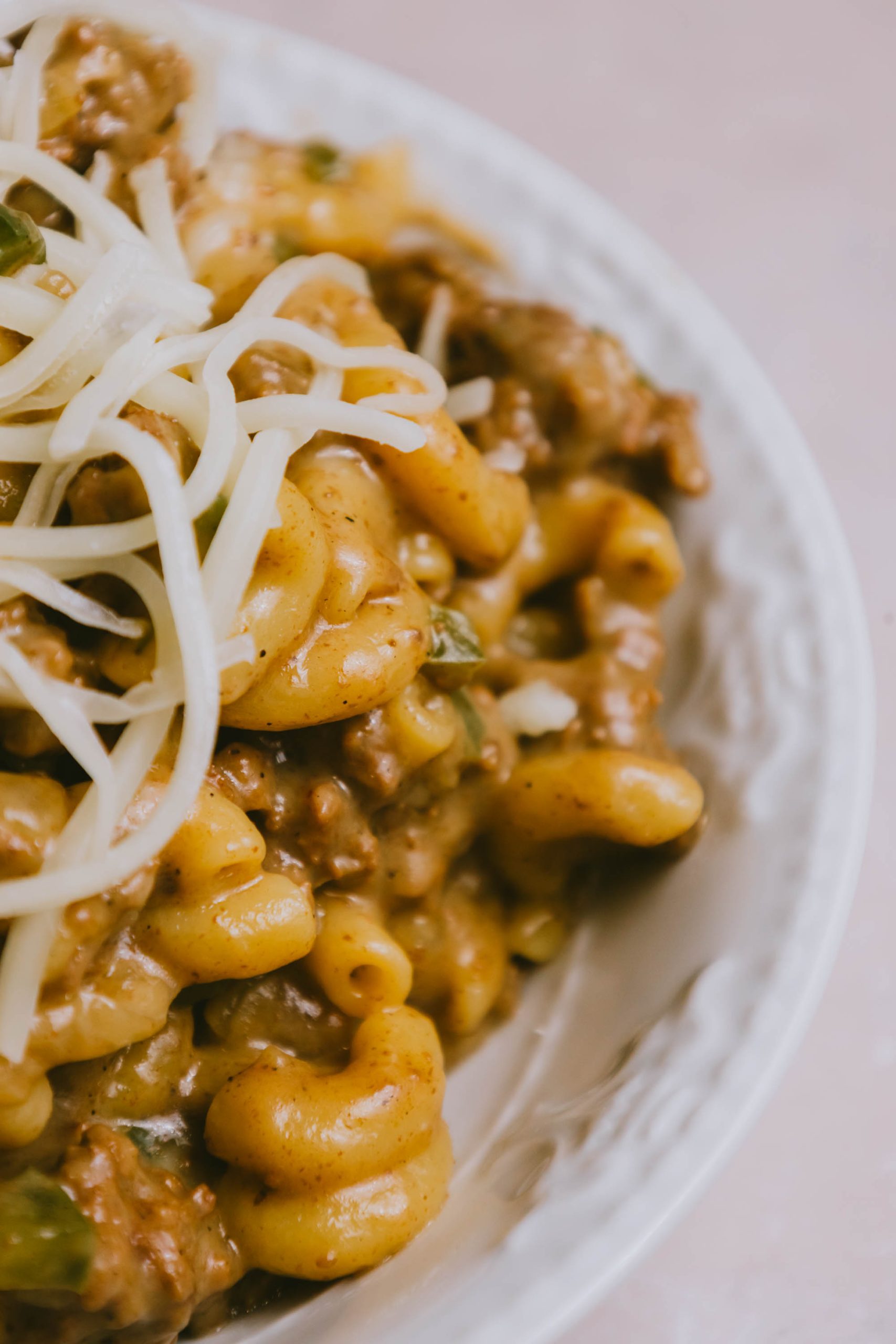 A plate of Ground Beef Philly Cheesesteak Casserole with meat and cheese.