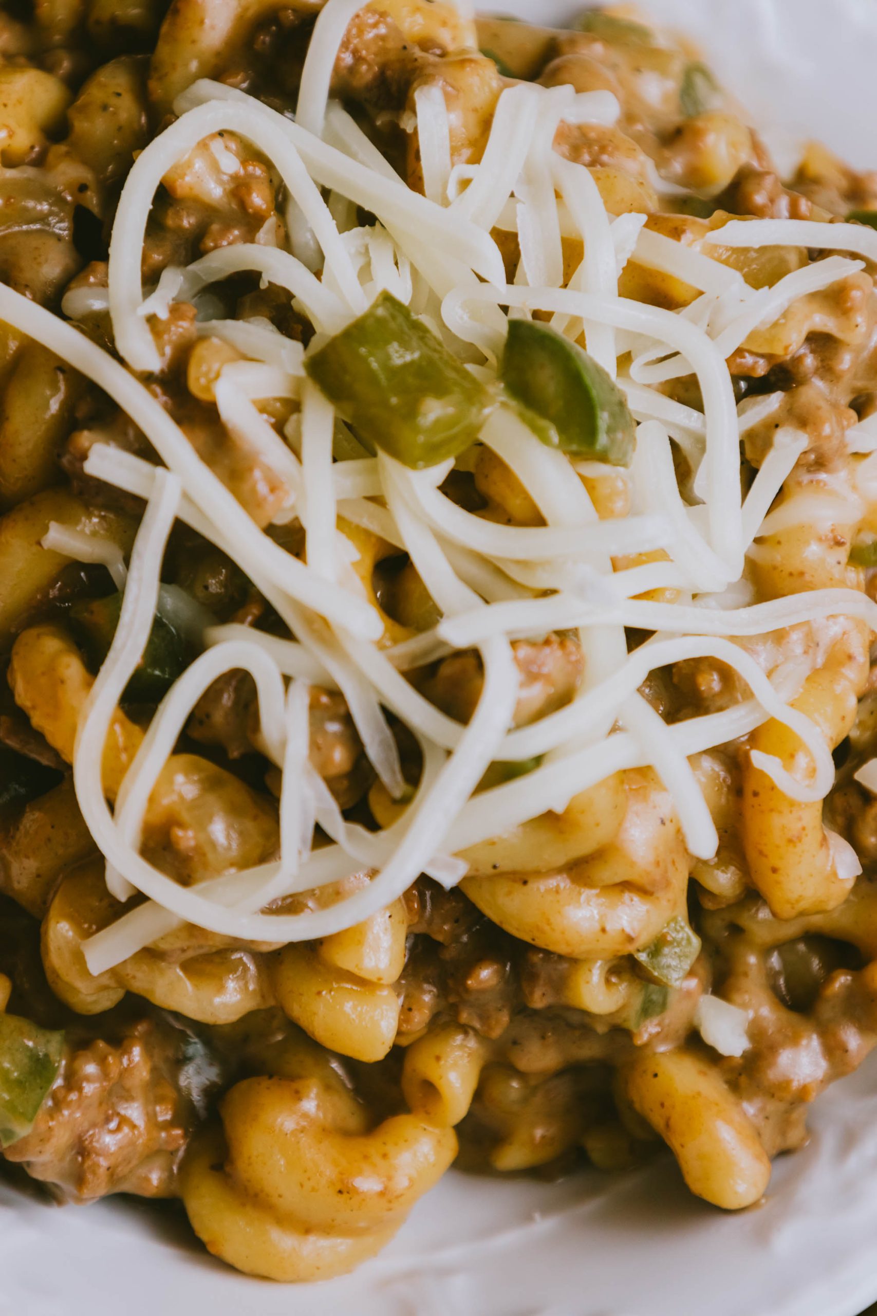 Cheesy Ground Beef Philly Cheesesteak Casserole with peppers and cheese on a plate.