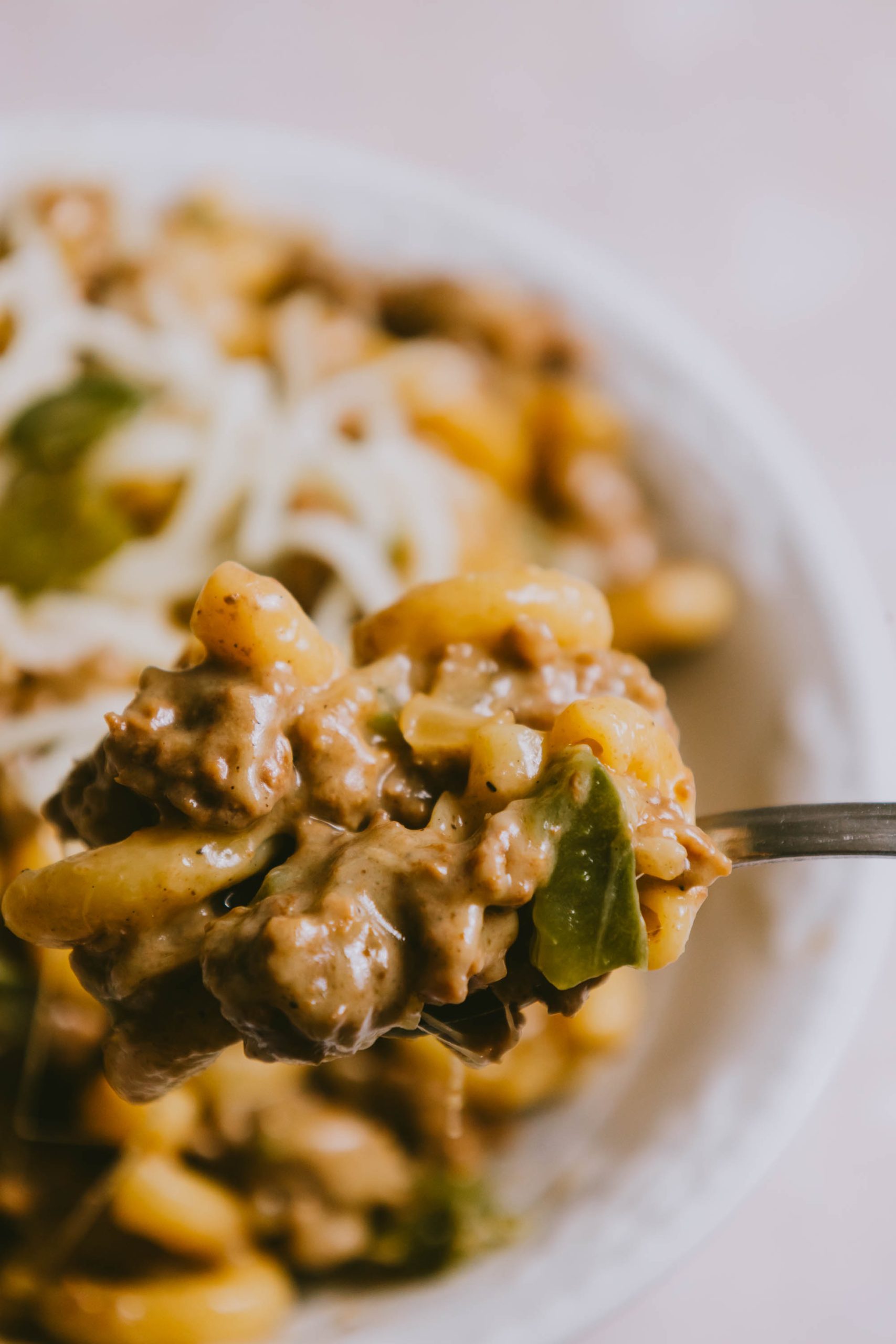 Cheesy macaroni and cheese in a white bowl.