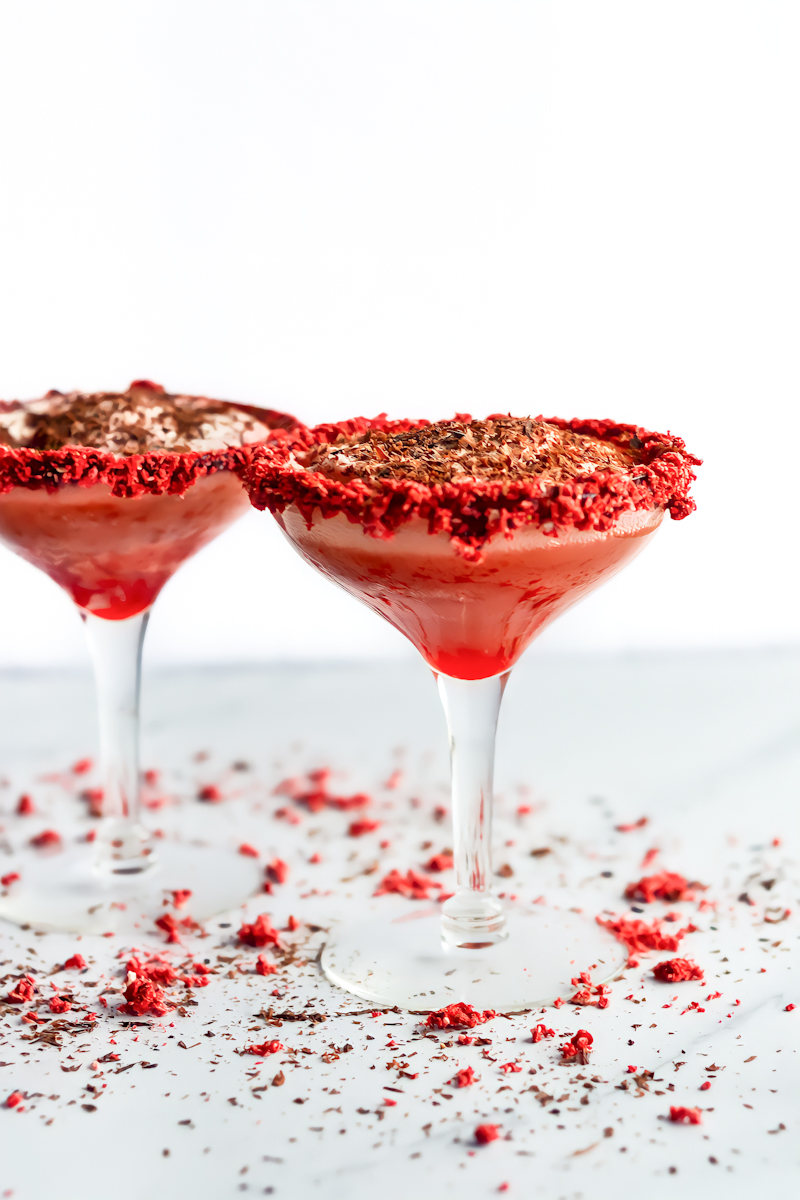 Two martinis with red icing and chocolate sprinkles.