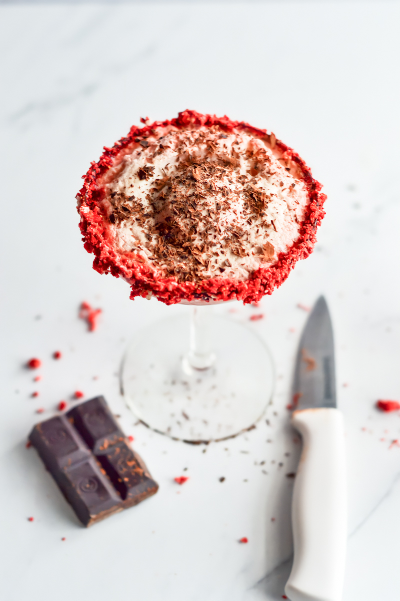 A red velvet martini with whipped cream and chocolate.