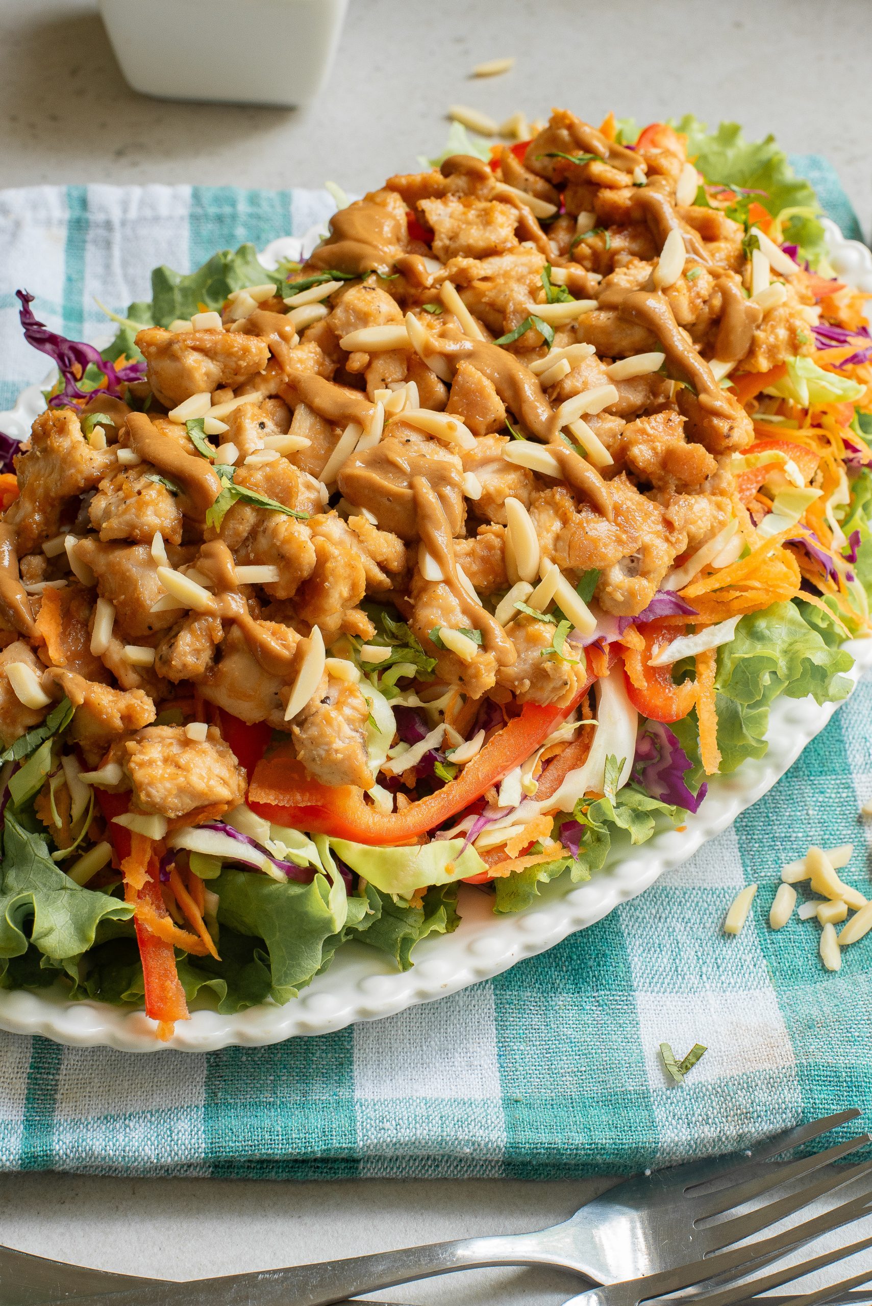 A plate with a salad on it and a fork on it.