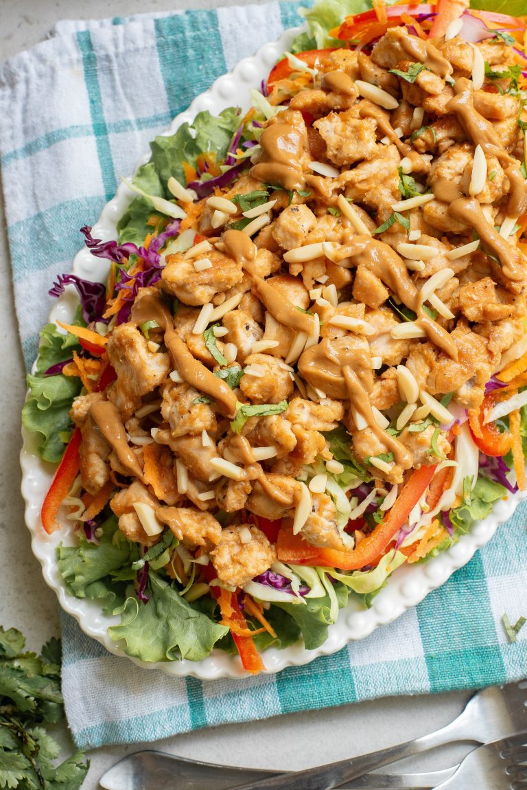 Chicken salad on a white plate with a fork.