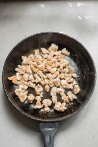 Fried chicken in a frying pan.