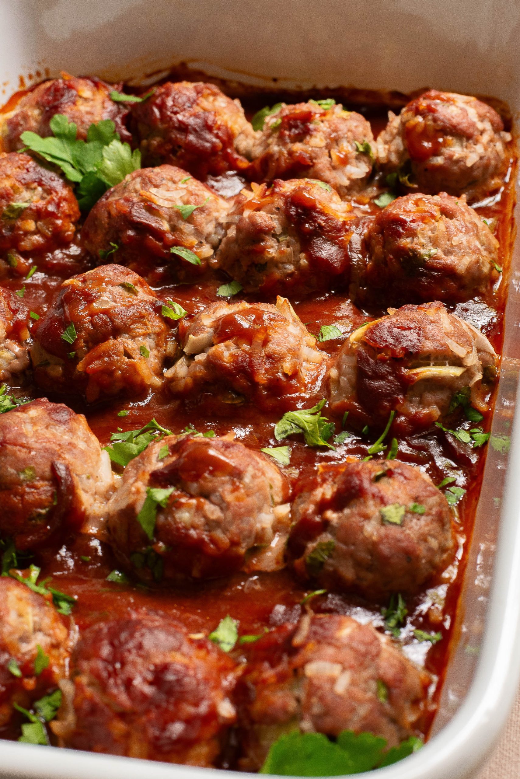 Meatballs in a pan with sauce.