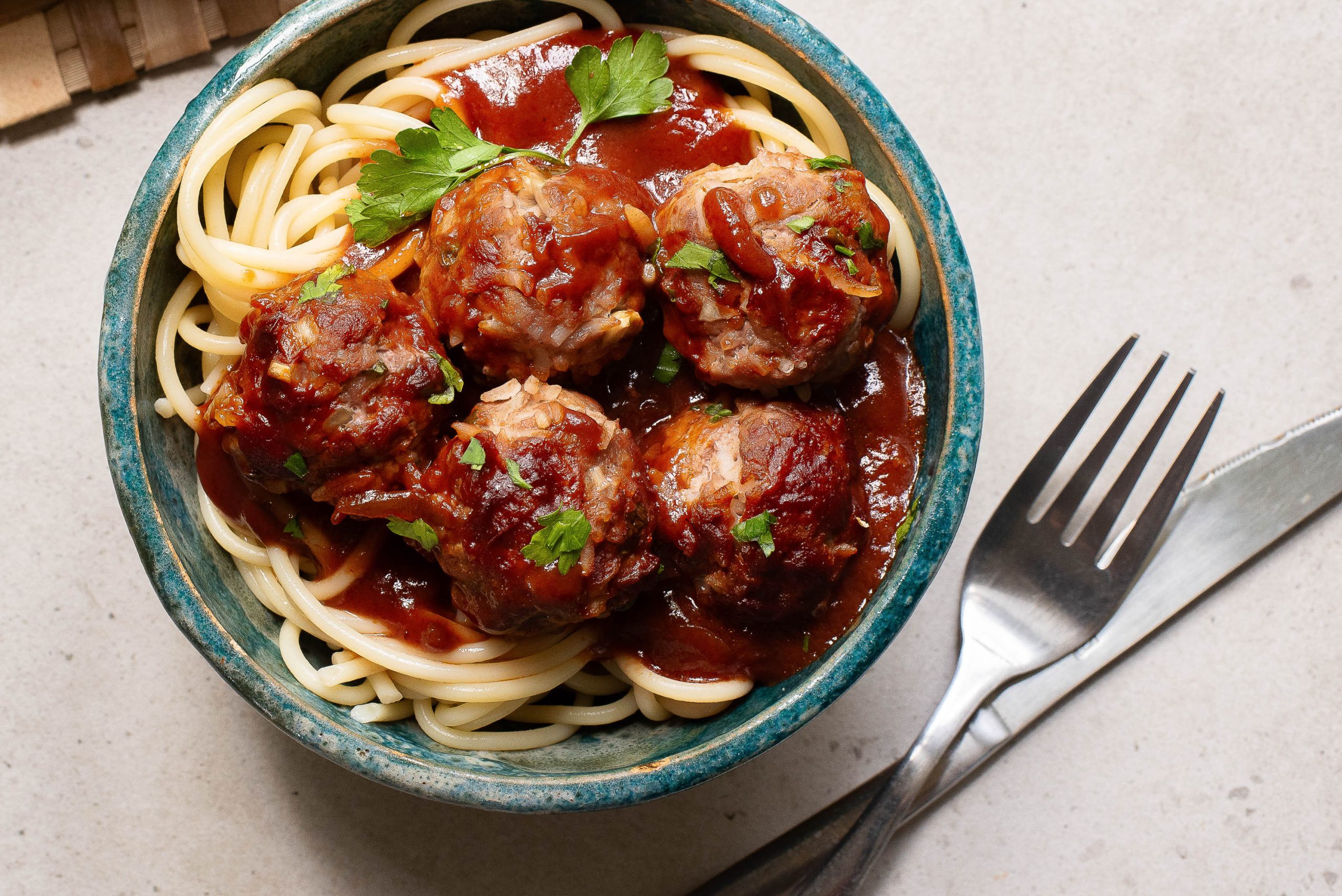 A bowl of spaghetti and porcupine meatballs.
