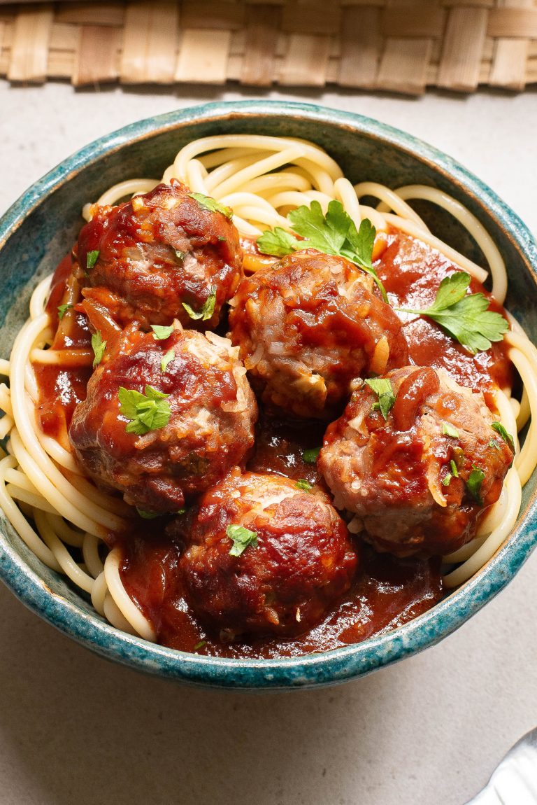 A bowl of spaghetti and meatballs.