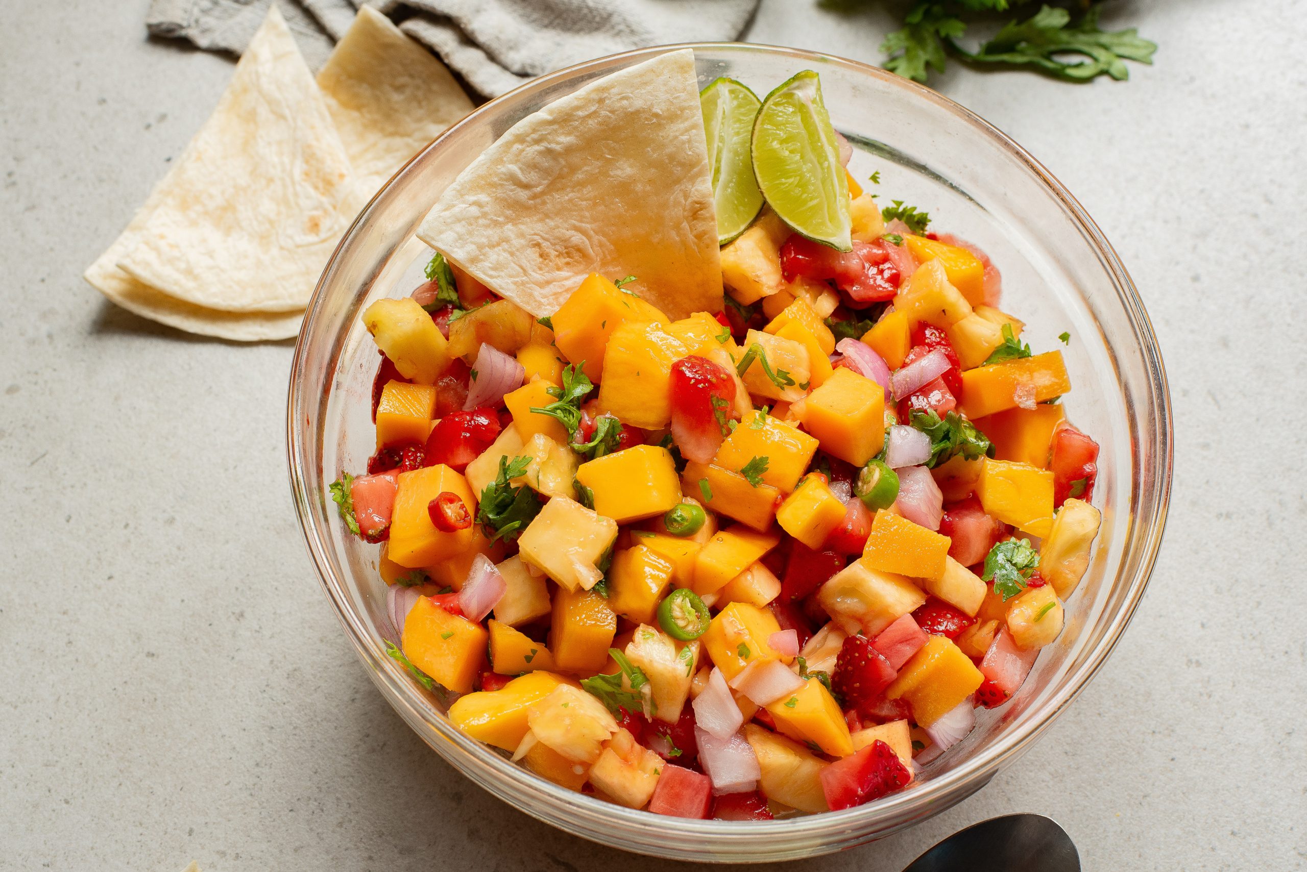 A bowl of salad setting on a table.