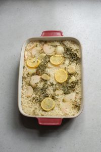 Casserole dish full of rice and herbs.
