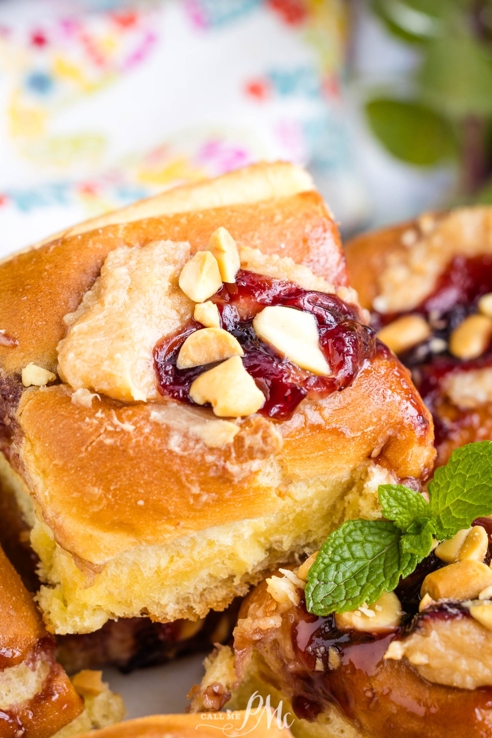 Close-up of a pb&j and nut topped pastry with visible layers