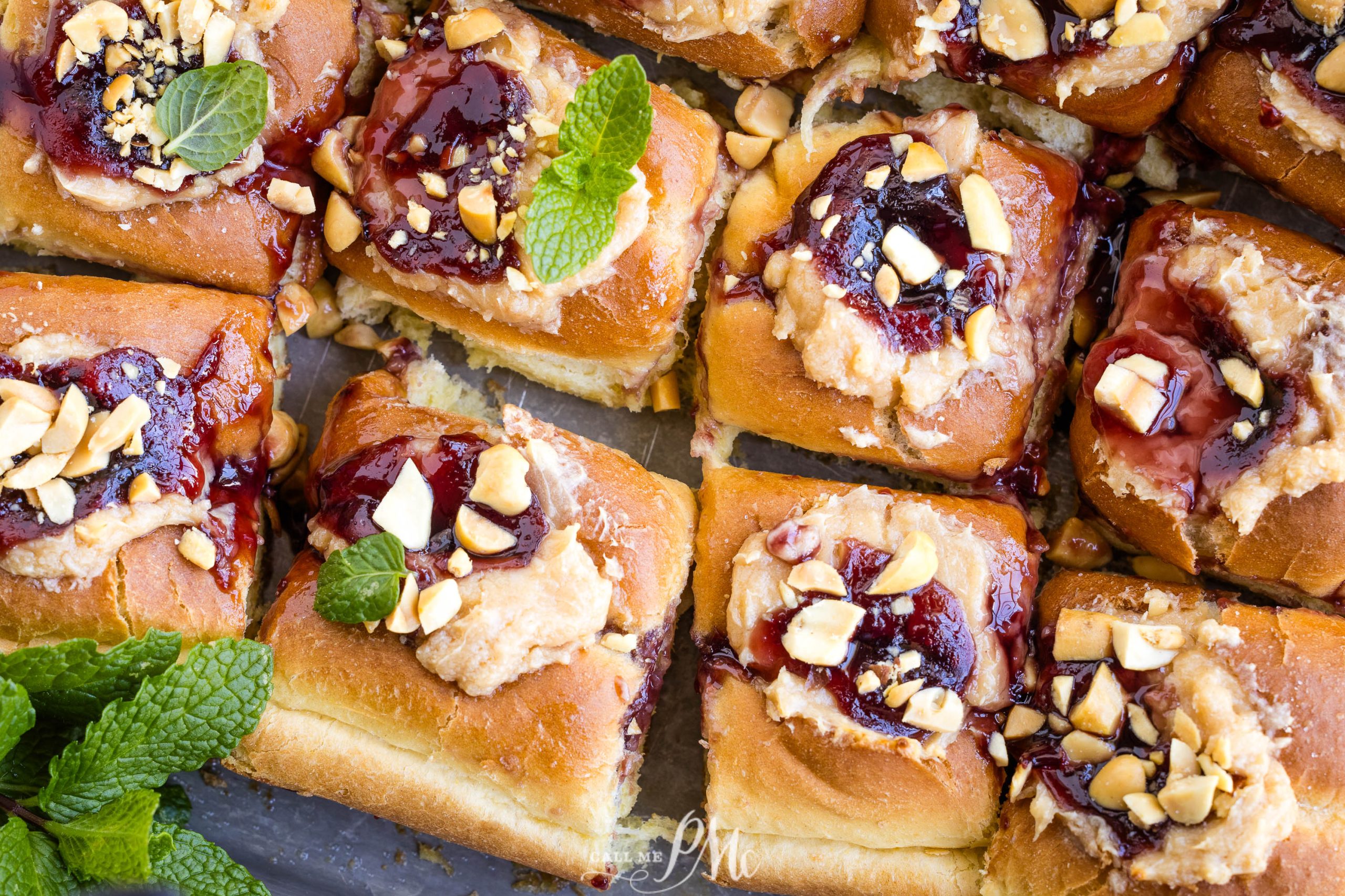 Freshly baked rolls topped with fruit jam and chopped nuts.