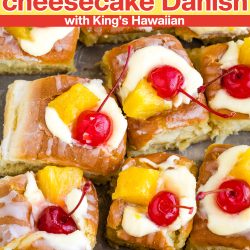 Pineapple and cherry-topped cheesecake danishes arranged in rows on a baking sheet, featuring king's hawaiian brand.