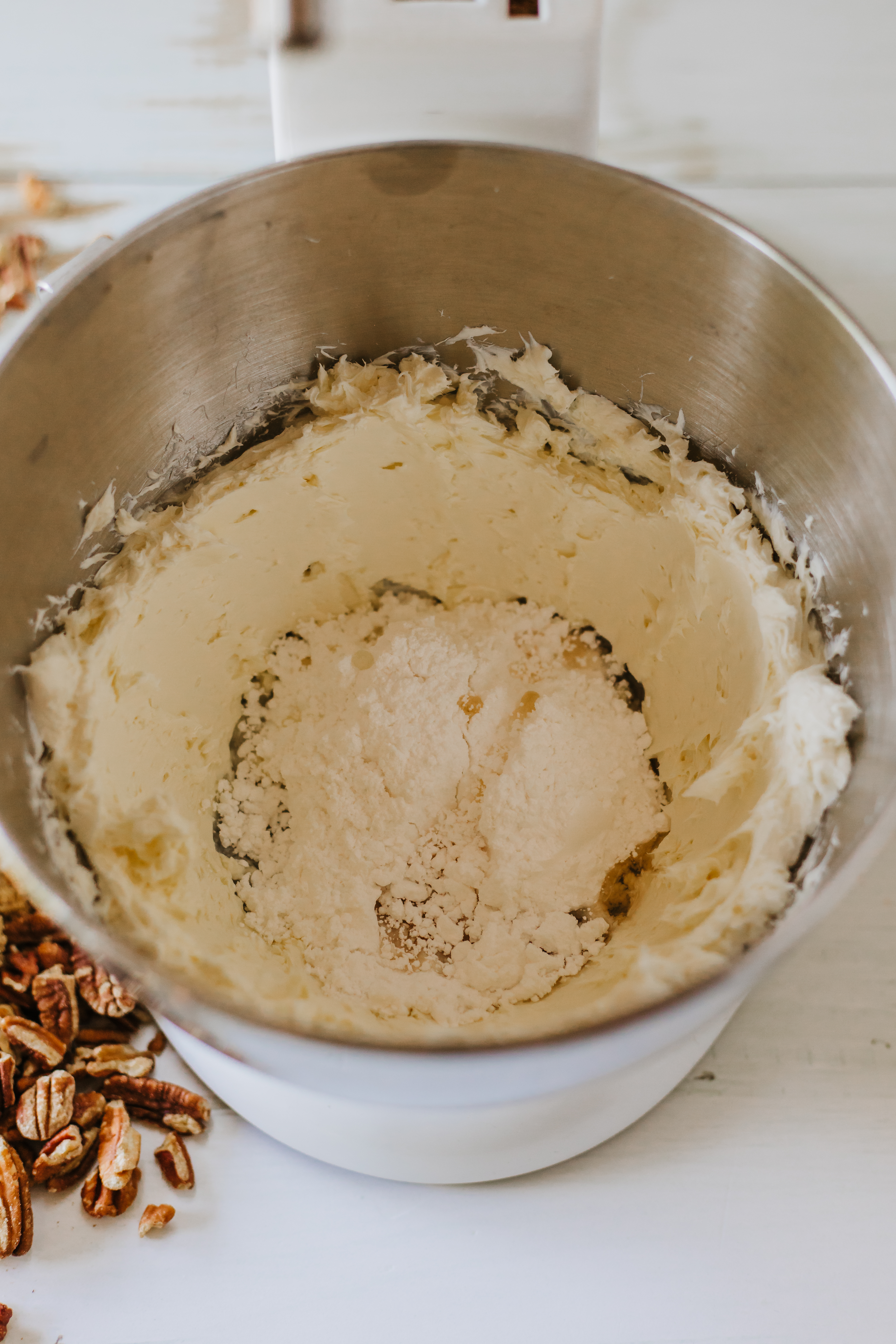 Cream cheese and powdered sugar in a mixing bowl.