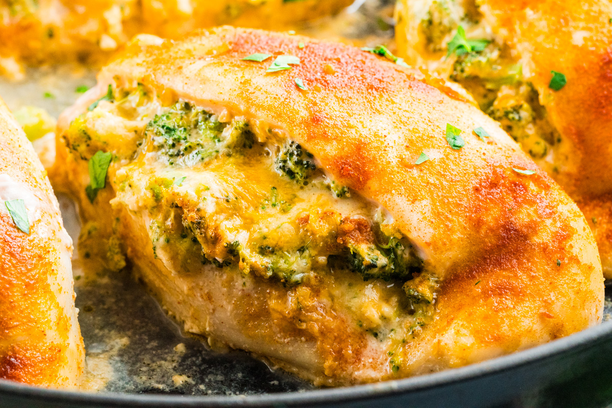 Close-up of buffalo stuffed chicken breast, cooked to perfection with cheese and herbs, topped with melted cheese and garnished with parsley.