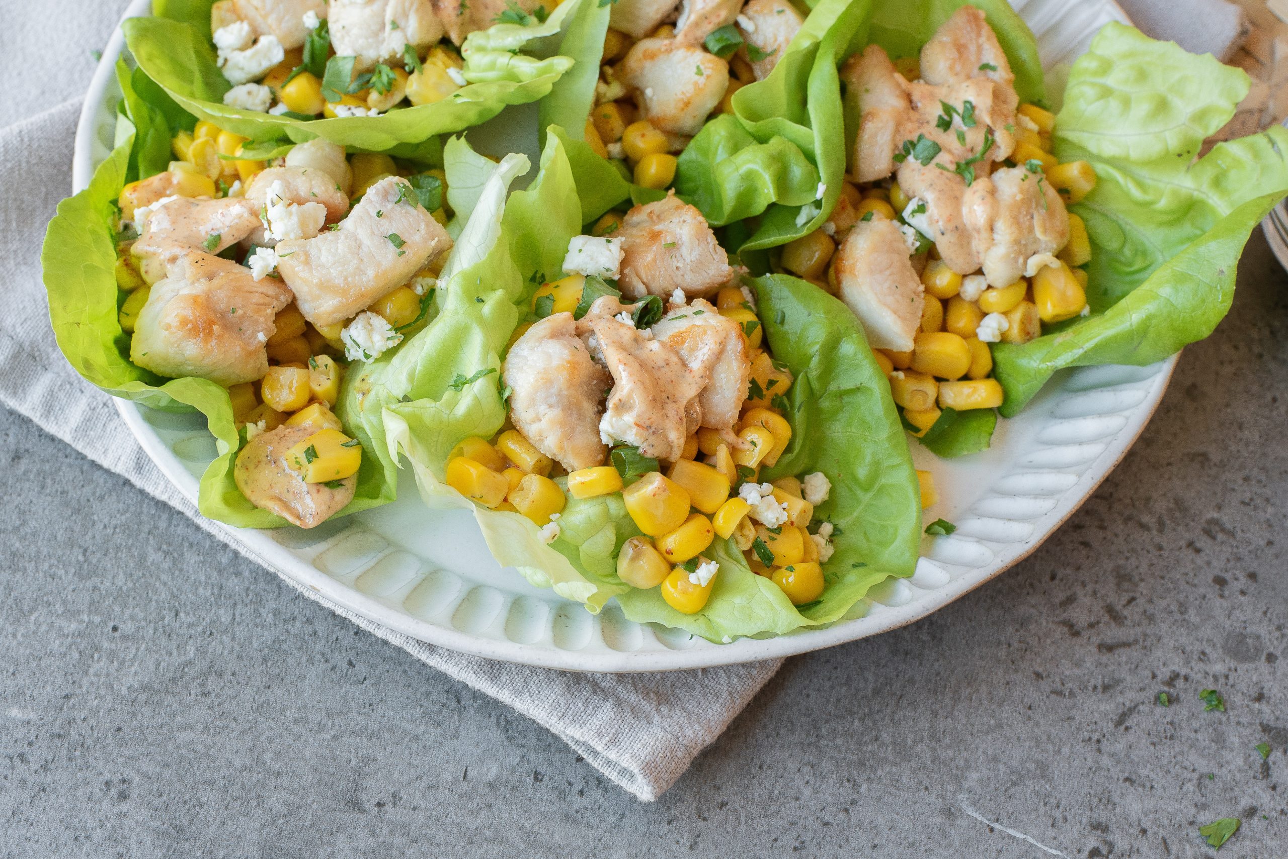 A plate of food on a textured gray surface.