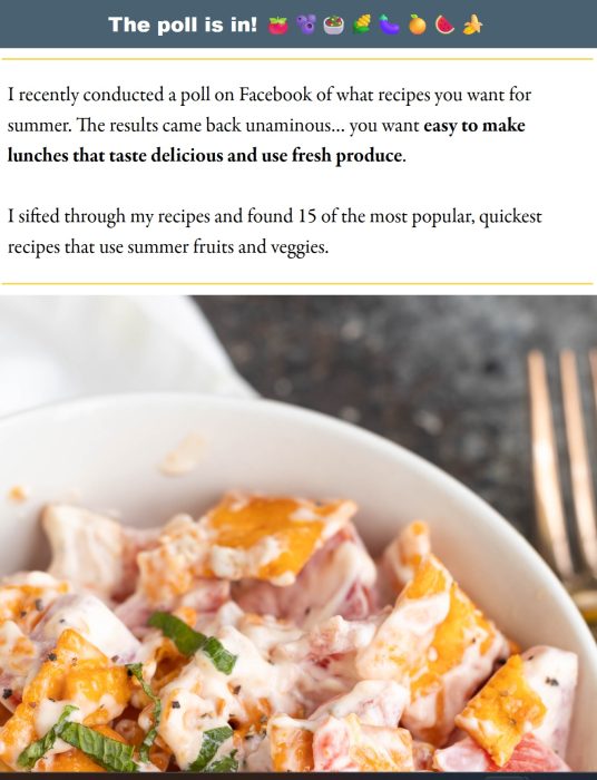 A close-up of a creamy summer salad with chopped peaches, tomatoes, and fresh herbs in a white bowl, next to a fork on a white surface.