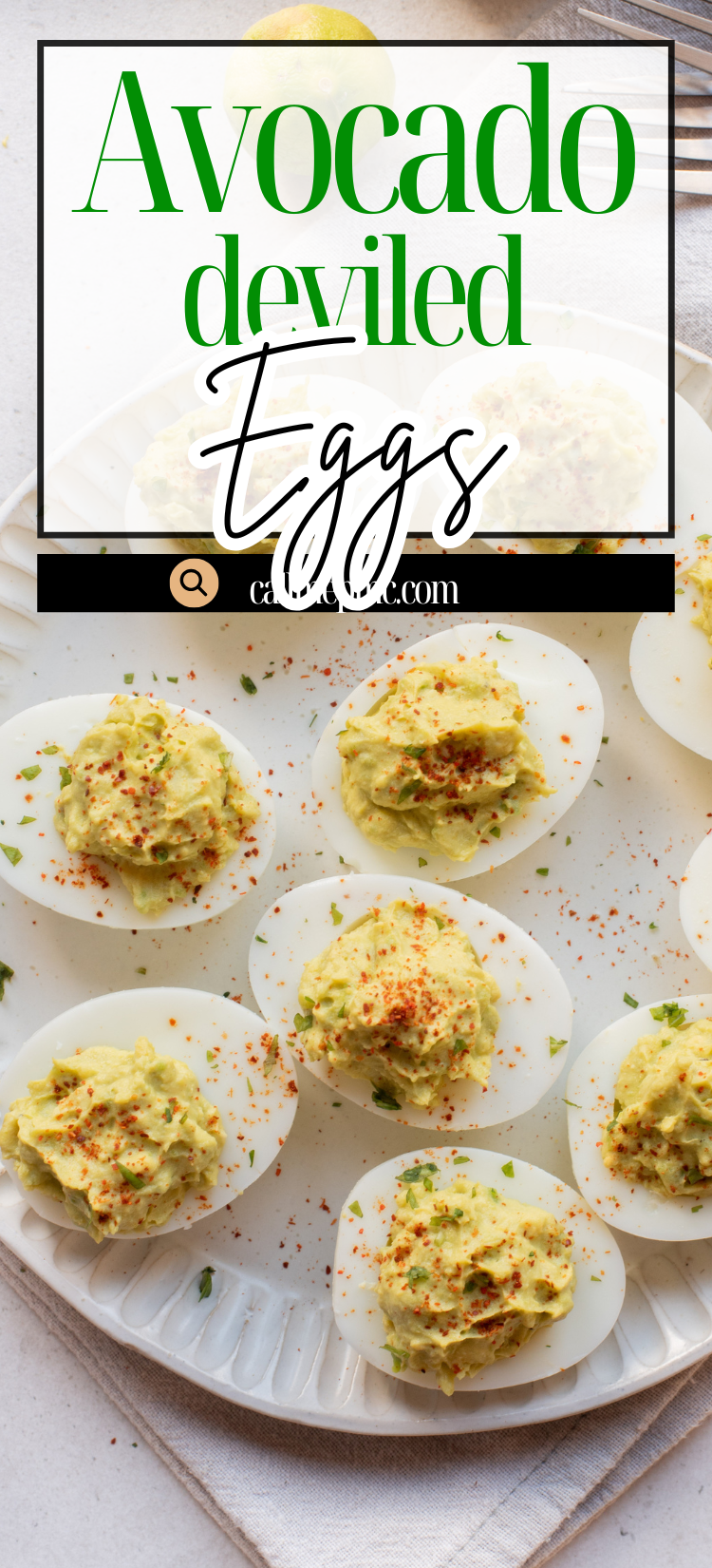 A plate of deviled eggs topped with paprika sits on a cloth napkin, with a fork and a lime in the background.