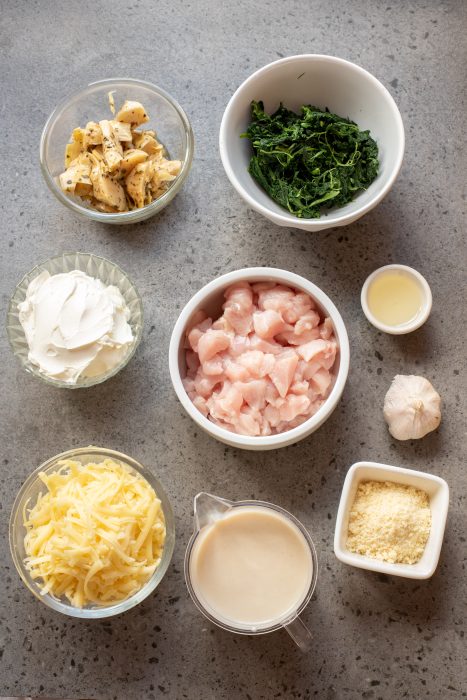 Bowls containing chopped ingredients on a grey countertop.