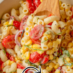 Bowl of summer corn tomato pasta with cherry tomatoes, corn, fresh herbs, and a creamy sauce, being stirred with a wooden spoon. Text overlay reads "Summer tomato corn pasta, fresh & flavorful.