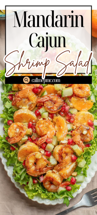 A platter of mandarin Cajun shrimp salad on leafy greens, topped with shrimp, mandarin orange segments, pomegranate seeds, and diced vegetables.