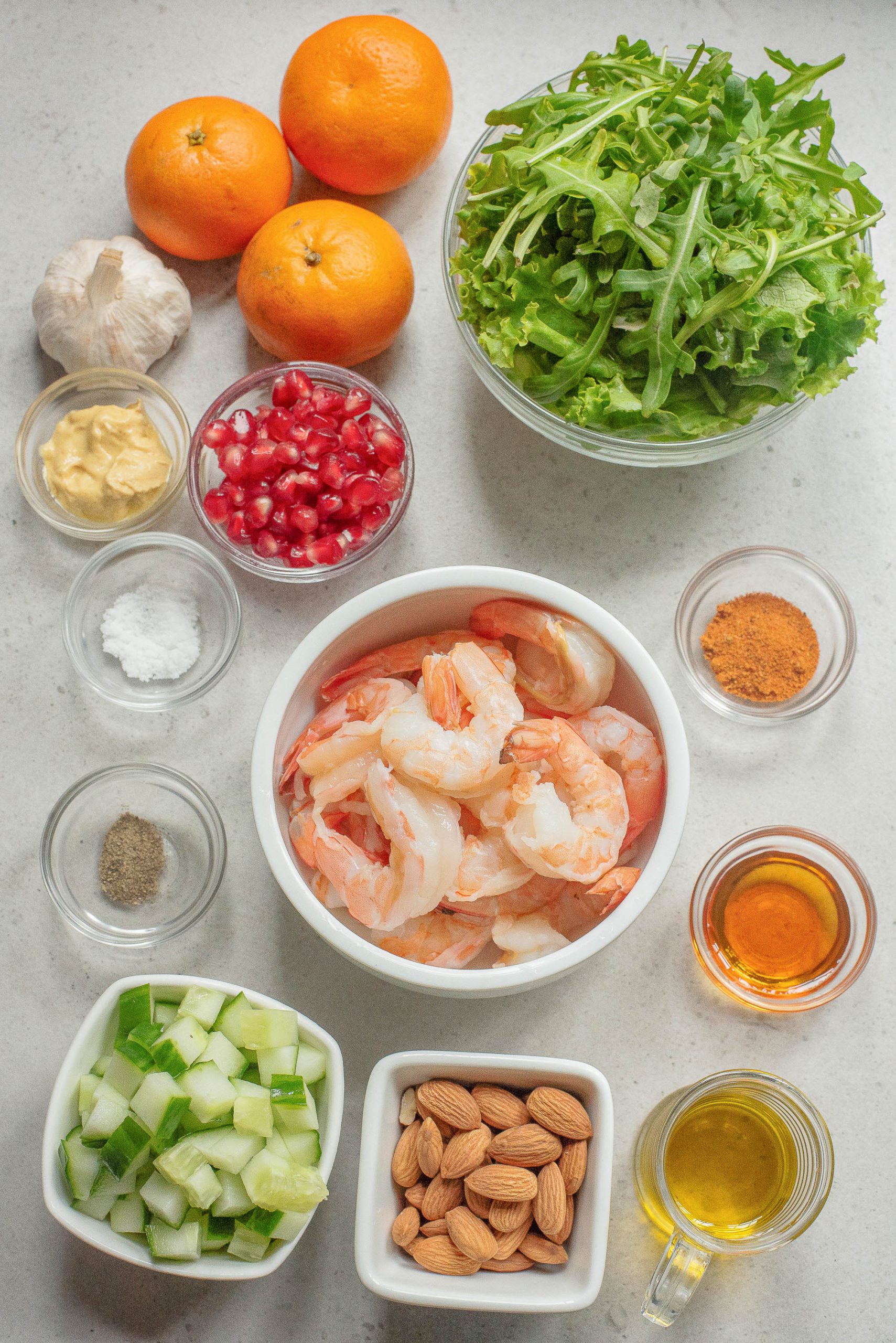 Overhead view of salad ingredients on a light surface.