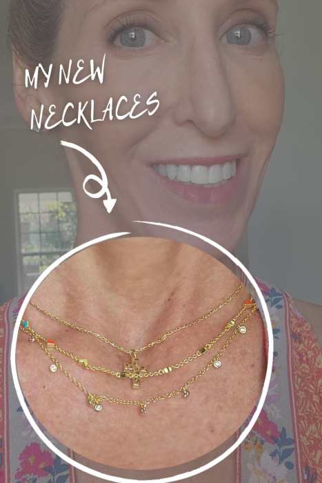 A smiling woman wearing three layered gold necklaces with small pendants, highlighted by a circular overlay and the text "MY NEW NECKLACES" with an arrow pointing to the jewelry.