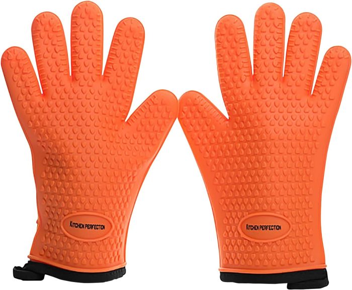 A pair of orange textured silicone oven gloves with black cuffs, labeled "KITCHEN PERFECTION" on the palm area—perfect outdoor cooking gifts for anyone who loves to grill or barbecue.