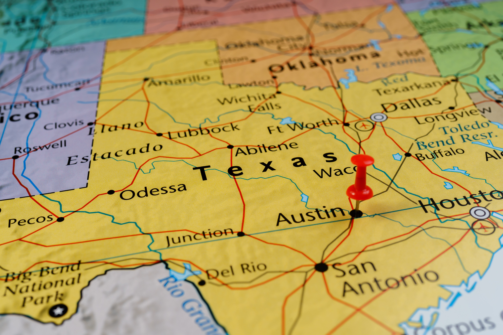 A map of Texas with a red pushpin marking the location of Austin; nearby cities and state borders are visible, perfect for planning your Road Trip Essentials.
