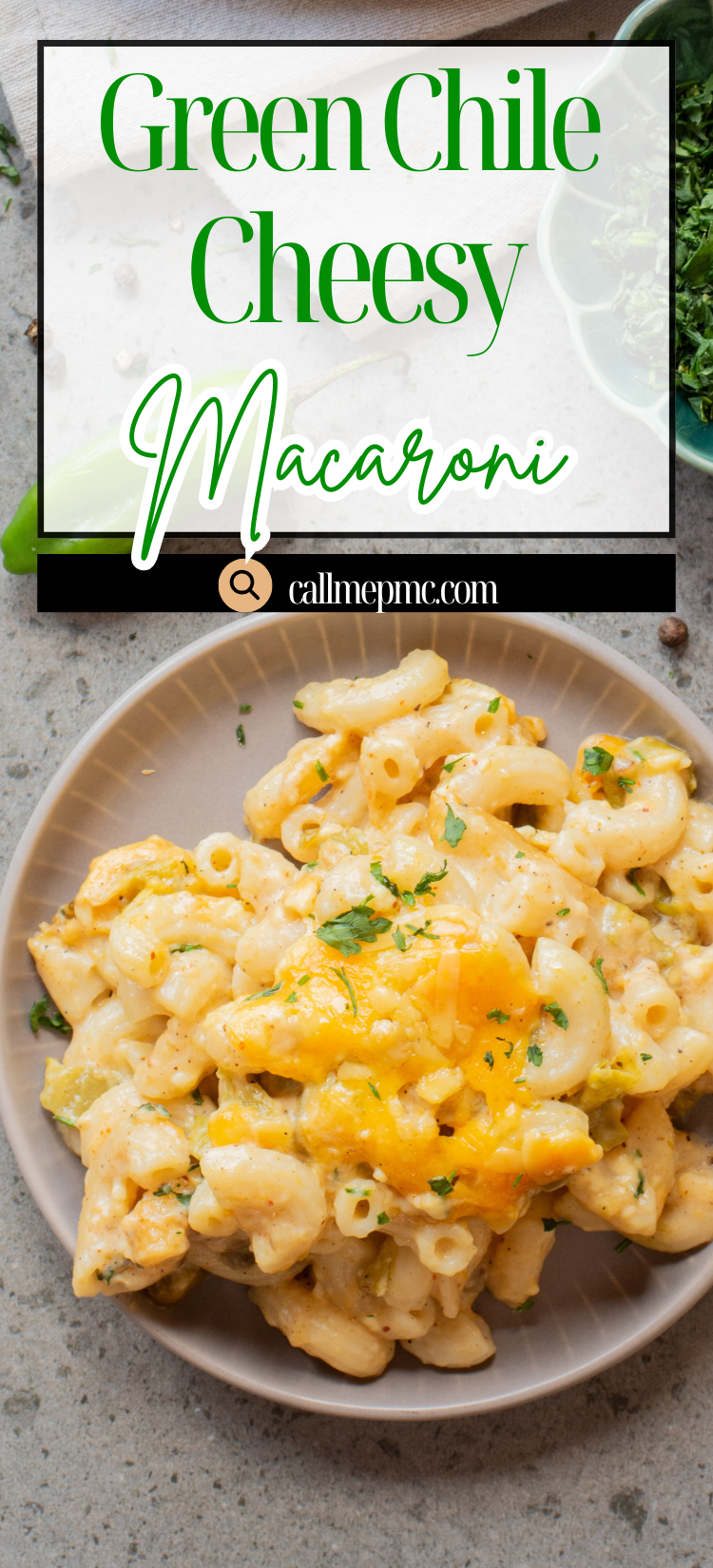 A plate of macaroni mixed with cheese and green chiles, garnished with chopped herbs, sits on a light-colored table.