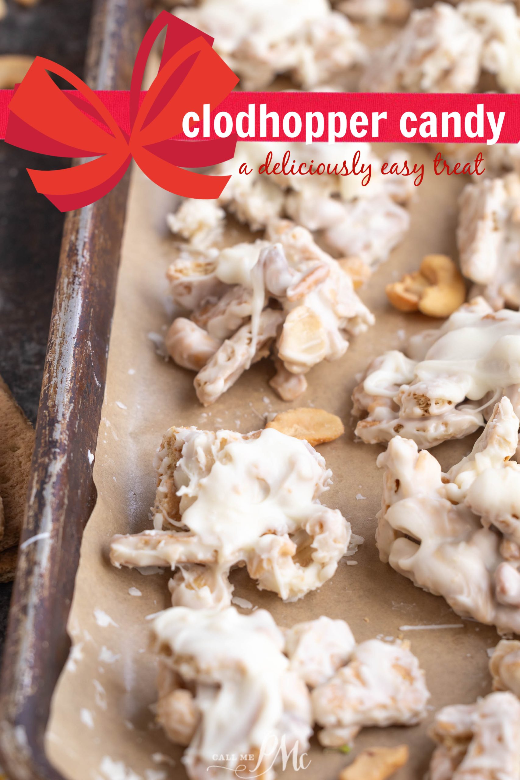 A baking tray lined with parchment paper holds clusters chocolate.